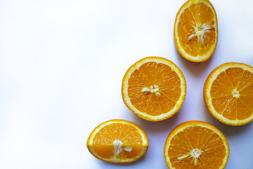 Orange slices arranged in a corner on a white background