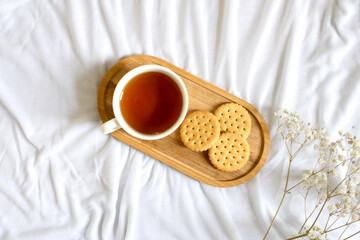 Tea and crackers on the bed, morning concept