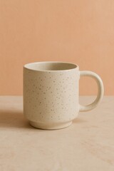 A ceramic coffee mug placed on a table with soft, warm lighting