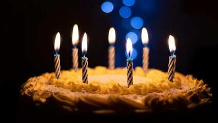 A birthday cake with lit candles against a dark background celebrating joyful festive moments for anniversaries and celebrations.