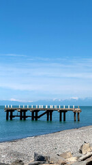 Aged Concrete Pier with Broken Columns Extending into Calm Sea