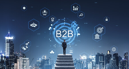 Businessman looking at B2B digital icons over cityscape, symboli