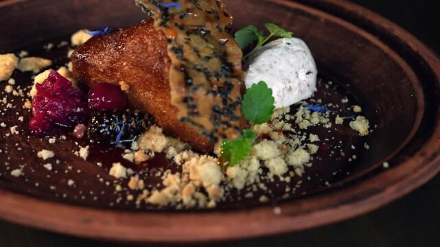 On a plate, honey cake is served with whipped cream and berries.