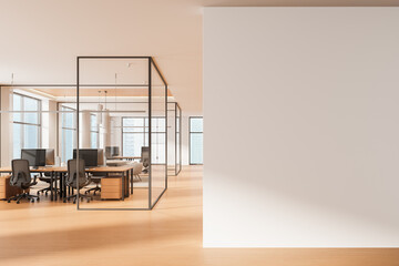 Fototapeta na wymiar Modern office interior with glass walls and large blank poster mockup on clean white wall in bright open workspace illuminated by natural light. 3D Rendering