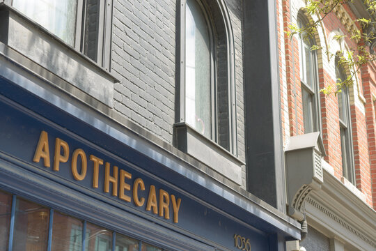 exterior building facade and sign of Prequel & Co. Apothecary, a cocktail bar, located at 1036 Queen St W, Toronto