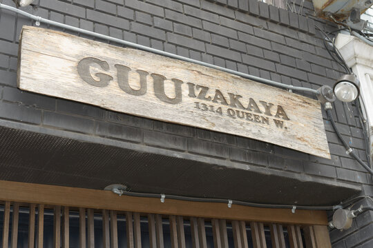 exterior storefront sign of Guu Izakaya, a Japanese restaurant, located at 1314 Queen St W, Toronto