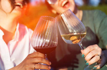 People clinking glasses of wine on a summer terrace of a cafe or restaurant