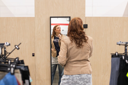 a genZ woman shopping in a thrift store