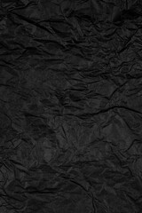 Crumpled Black Paper Texture. Dark Wrinkled Background. Stock photo.