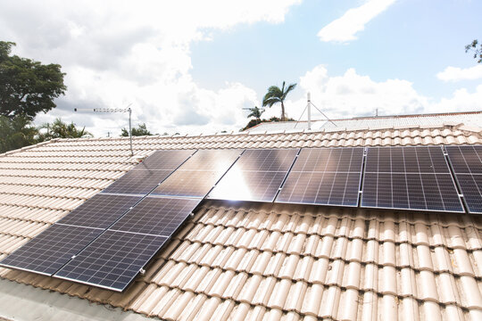 solar panels on a tile rooftop on a sunny day