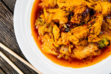 Sichuan fried chicken with vegetables on a dark background. Chinese cuisine. Food concept