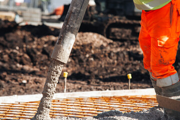 Close-up of Worker operates concrete pump at construction site