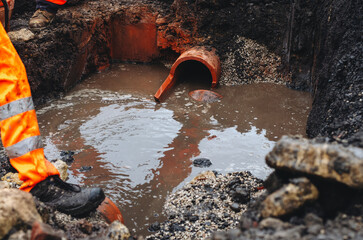 Fast response repair team builders replacing damaged foul sewer drainage pipe