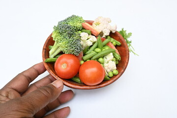 Vibrant medley of fresh vegetables. Features broccoli, cauliflower, tomatoes, Carrot, green beans, and peas. colourful vegetables of spring time, Its good for health. colorful display.