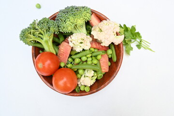 Vibrant medley of fresh vegetables. Features broccoli, cauliflower, tomatoes, Carrot, green beans, and peas. colourful vegetables of spring time, Its good for health. colorful display.
