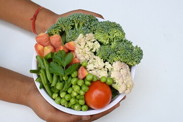 Vibrant medley of fresh vegetables. Features broccoli, cauliflower, tomatoes, Carrot, green beans, and peas. colourful vegetables of spring time, Its good for health. colorful display.