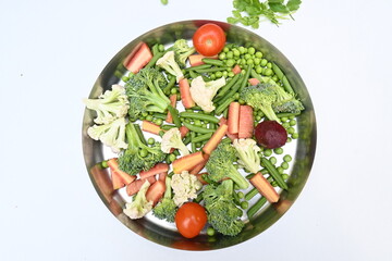 Vibrant medley of fresh vegetables. Features broccoli, cauliflower, tomatoes, Carrot, green beans, and peas. colourful vegetables of spring time, Its good for health. colorful display.