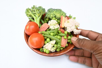 Vibrant medley of fresh vegetables. Features broccoli, cauliflower, tomatoes, Carrot, green beans, and peas. colourful vegetables of spring time, Its good for health. colorful display.