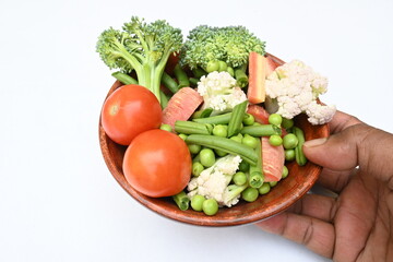 Vibrant medley of fresh vegetables. Features broccoli, cauliflower, tomatoes, Carrot, green beans, and peas. colourful vegetables of spring time, Its good for health. colorful display.
