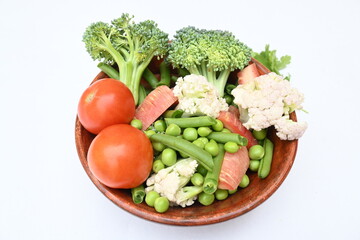 Vibrant medley of fresh vegetables. Features broccoli, cauliflower, tomatoes, Carrot, green beans, and peas. colourful vegetables of spring time, Its good for health. colorful display.