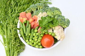 Vibrant medley of fresh vegetables. Features broccoli, cauliflower, tomatoes, Carrot, green beans, and peas. colourful vegetables of spring time, Its good for health. colorful display.