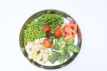 Vibrant medley of fresh vegetables. Features broccoli, cauliflower, tomatoes, Carrot, green beans, and peas. colourful vegetables of spring time, Its good for health. colorful display.