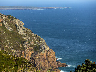 Green grass, rocks and rocky cliffs and slopes on the Atlantic Ocean coast in the Lisbon area	
