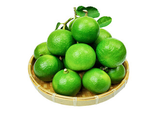 Green lime with green leaf in basket isolated on white background. clipping path.