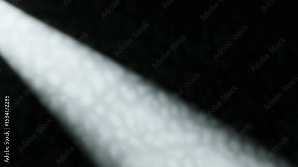 Poster volumetric light beam slowly emerging through dark space, casting mysterious shadows and creating dr