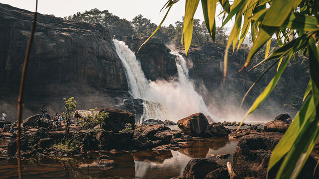 Powerful Waterfall Cascading Amidst Rugged Rocks and Lush Greenery with Misty Spray. Athirappilly Waterfall, the "Niagara of India".