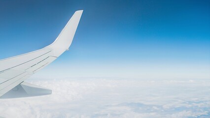 Obraz premium Awesome view of the Earth under the airplane wing. Amazing landscape is visible through airplane window. Traveling by plane. Flying in the cumulus sky among clouds.