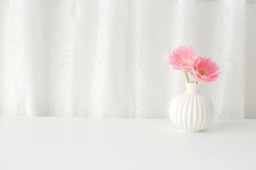 flowers in white pot on the table