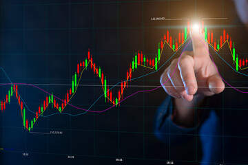 Stock market analyst pointing at upward trend line on trading chart during trading hours