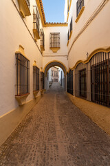 Beautiful street in the old town of the city of Ronda at sunset. Malaga, Andalucia, Spain.