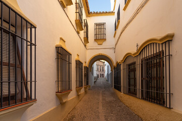 Beautiful street in the old town of the city of Ronda at sunset. Malaga, Andalucia, Spain.