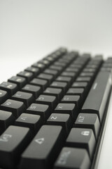 A mechanical keyboard with a 61% layout in black from the top with a white background.