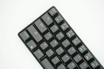 A mechanical keyboard with a 61% layout in black from the top with a white background.