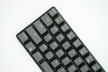 A mechanical keyboard with a 61% layout in black from the top with a white background.