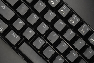 A black mechanical keyboard with a black background