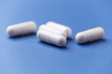 Arginine capsules on bright background. Soft focus. Close up. Copy space.	