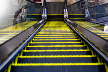Modern Escalator Descending with Yellow Safety Lines