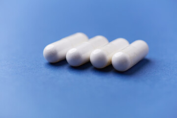 Arginine capsules on bright background. Soft focus. Close up. Copy space.	