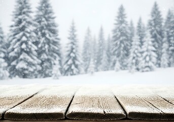 Snowy wooden table surface with winter forest and falling snow in the background