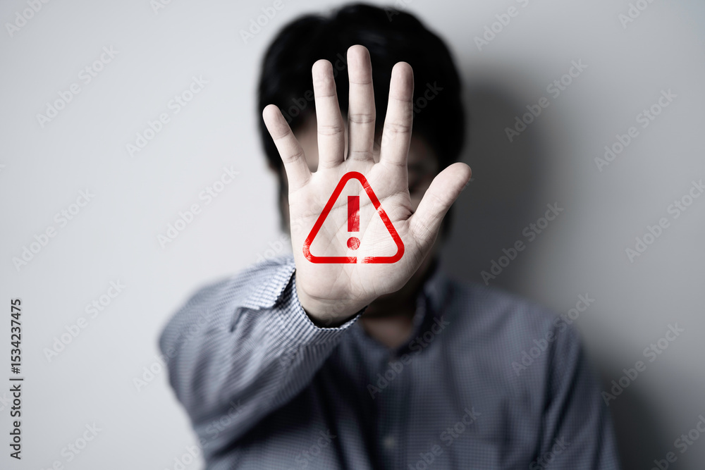 Poster businessman holding up hand with triangle caution warning sign for notification error and maintenanc