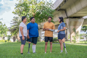 group of healthy multiracial friends including person with prosthetic legs talking and supporting together,gathering,exercise in garden
