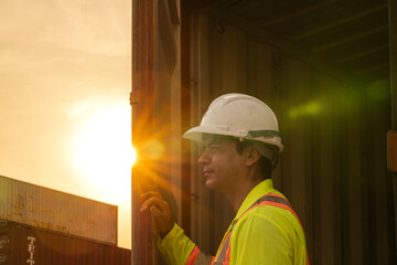 logistics workers man cheking open container box on site area operations at a busy shipping...