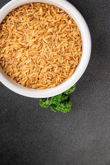 Brown rice whole grain cereal product superfood fresh tasty gourmet food background on the table rustic food top view copy space