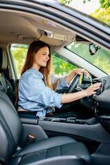 A confident young woman driving a car. Test-driving a new car or traveling.