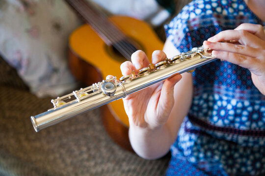 Young musical lady playing a flute