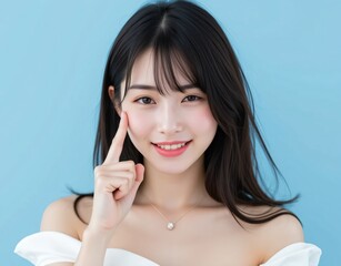 人差し指で頬の肌を指差す若い女性